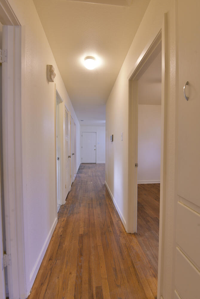 3013 2nd Street Lubbock, TX 79415 - Photo 20 of 21 a view of a hallway with wooden floor