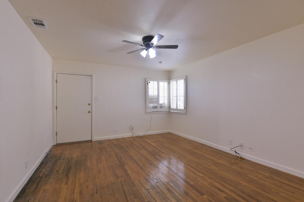 3013 2nd Street Lubbock, TX 79415 - Photo 4 of 21 a view of empty room with wooden floor and fan