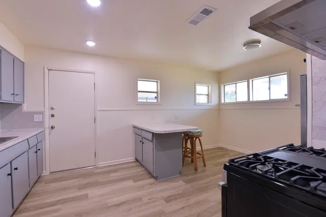 a kitchen that has a lot of cabinets in it