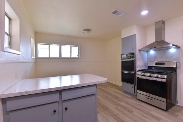 a kitchen with granite countertop a stove and a refrigerator