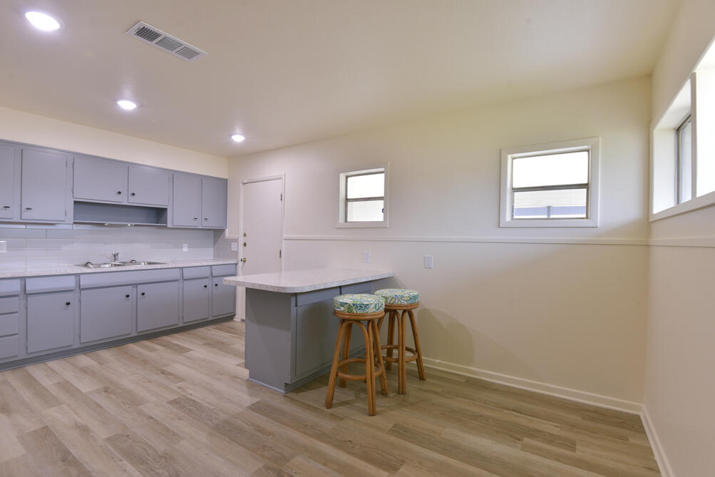 3013 2nd Street Lubbock, TX 79415 - Photo 8 of 21 a kitchen with a sink cabinets and wooden floor