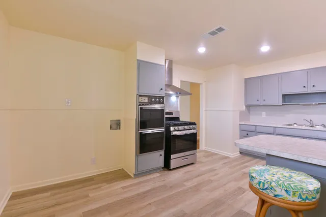 a kitchen with stainless steel appliances a stove and a refrigerator
