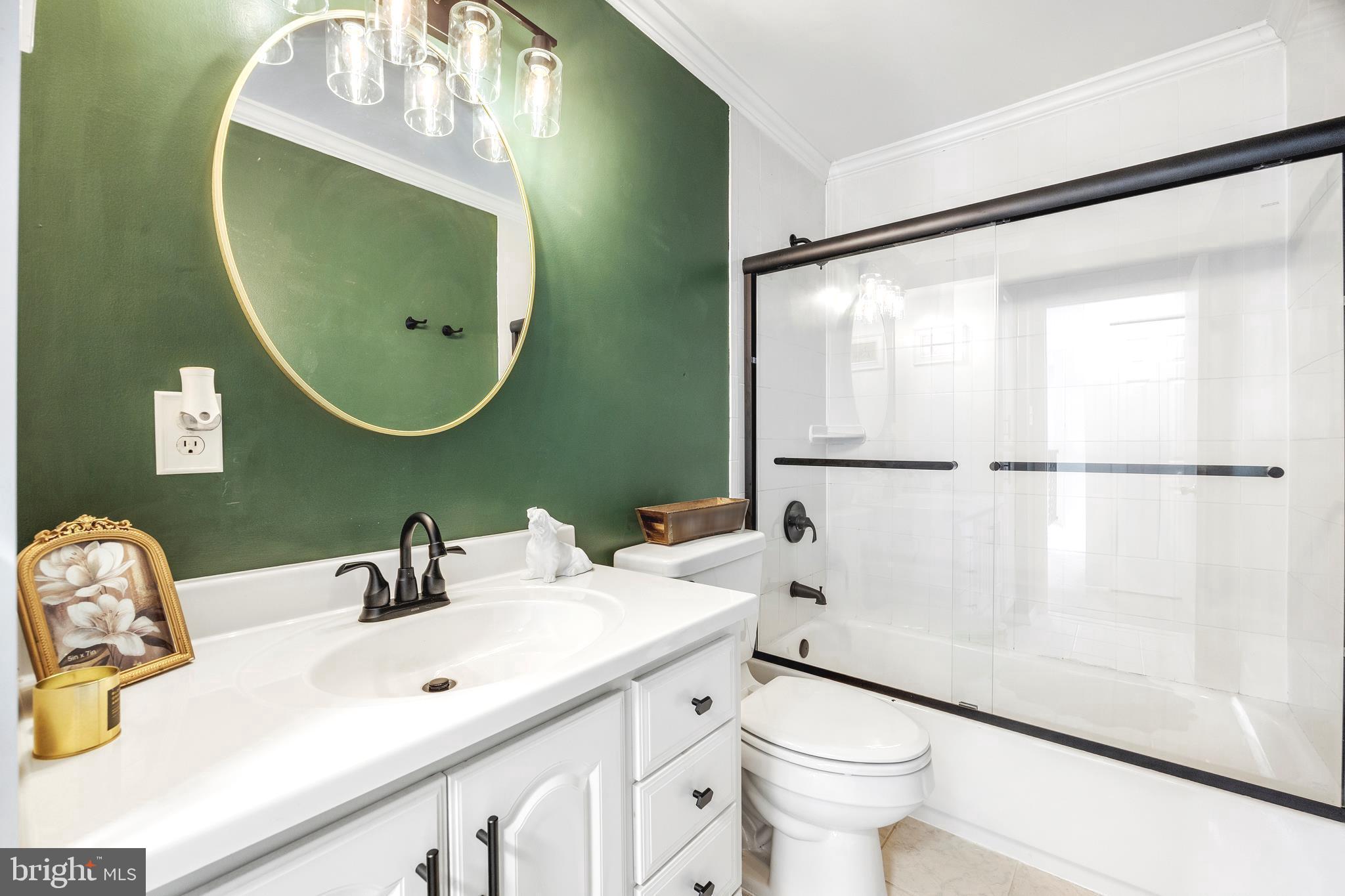 7740 Notley Road Pasadena, MD 21122 - Photo 12 of 46 a bathroom with a sink mirror vanity and toilet