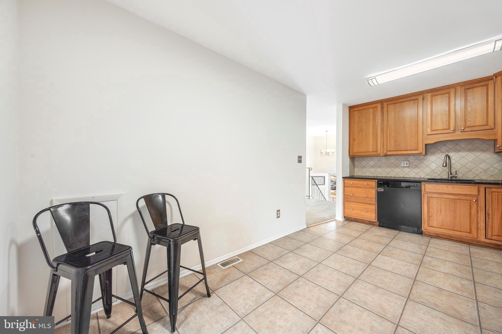 7740 Notley Road Pasadena, MD 21122 - Photo 15 of 46 a kitchen with granite countertop a stove a sink and a granite counter tops