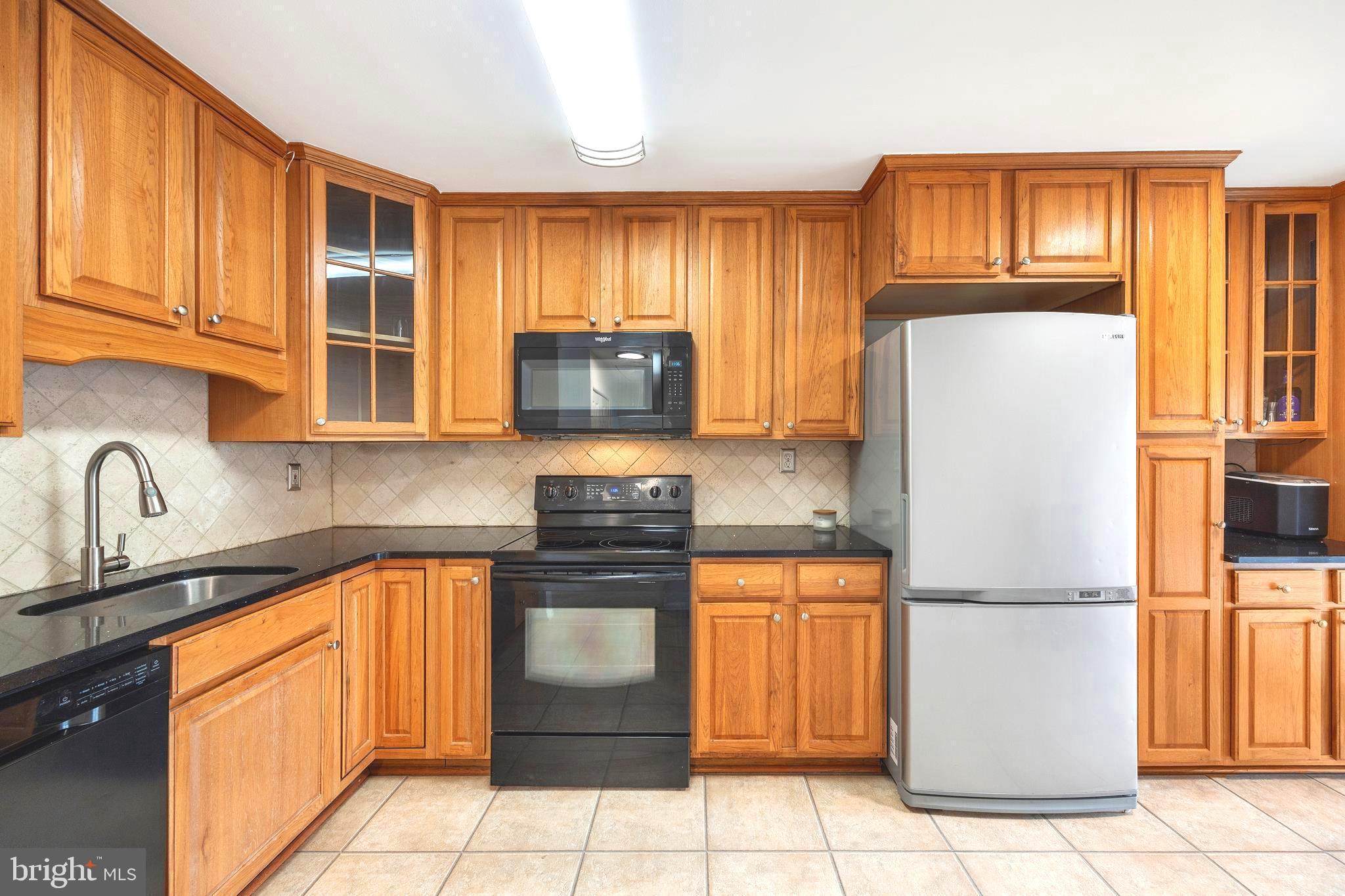 7740 Notley Road Pasadena, MD 21122 - Photo 2 of 46 a kitchen with stainless steel appliances granite countertop a refrigerator sink stove and microwave