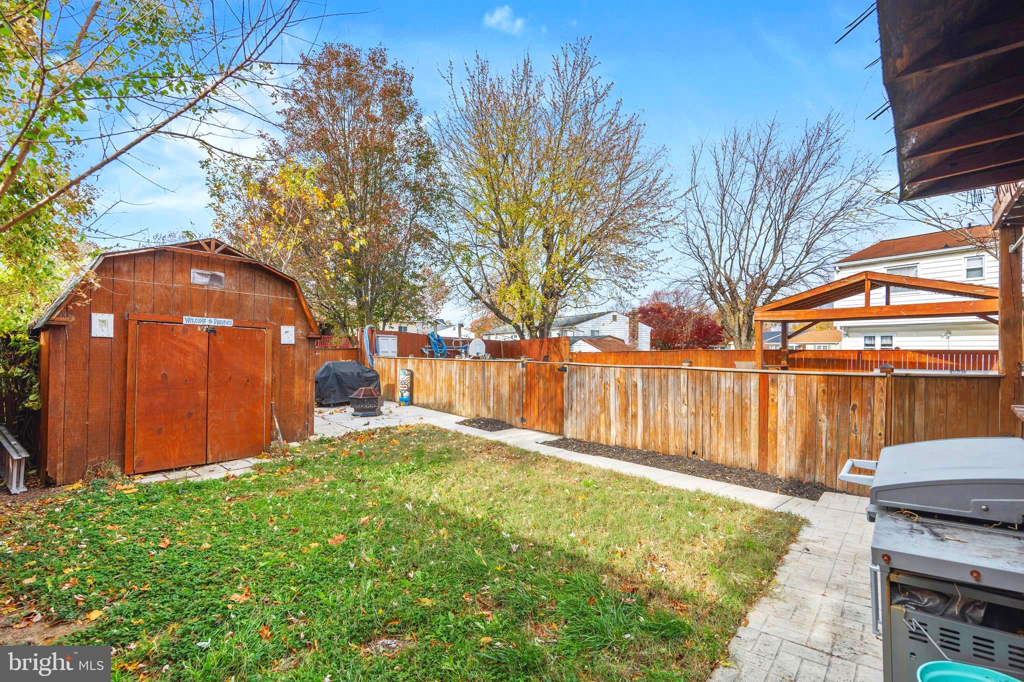 7740 Notley Road Pasadena, MD 21122 - Photo 30 of 46 a backyard of a house with table and chairs