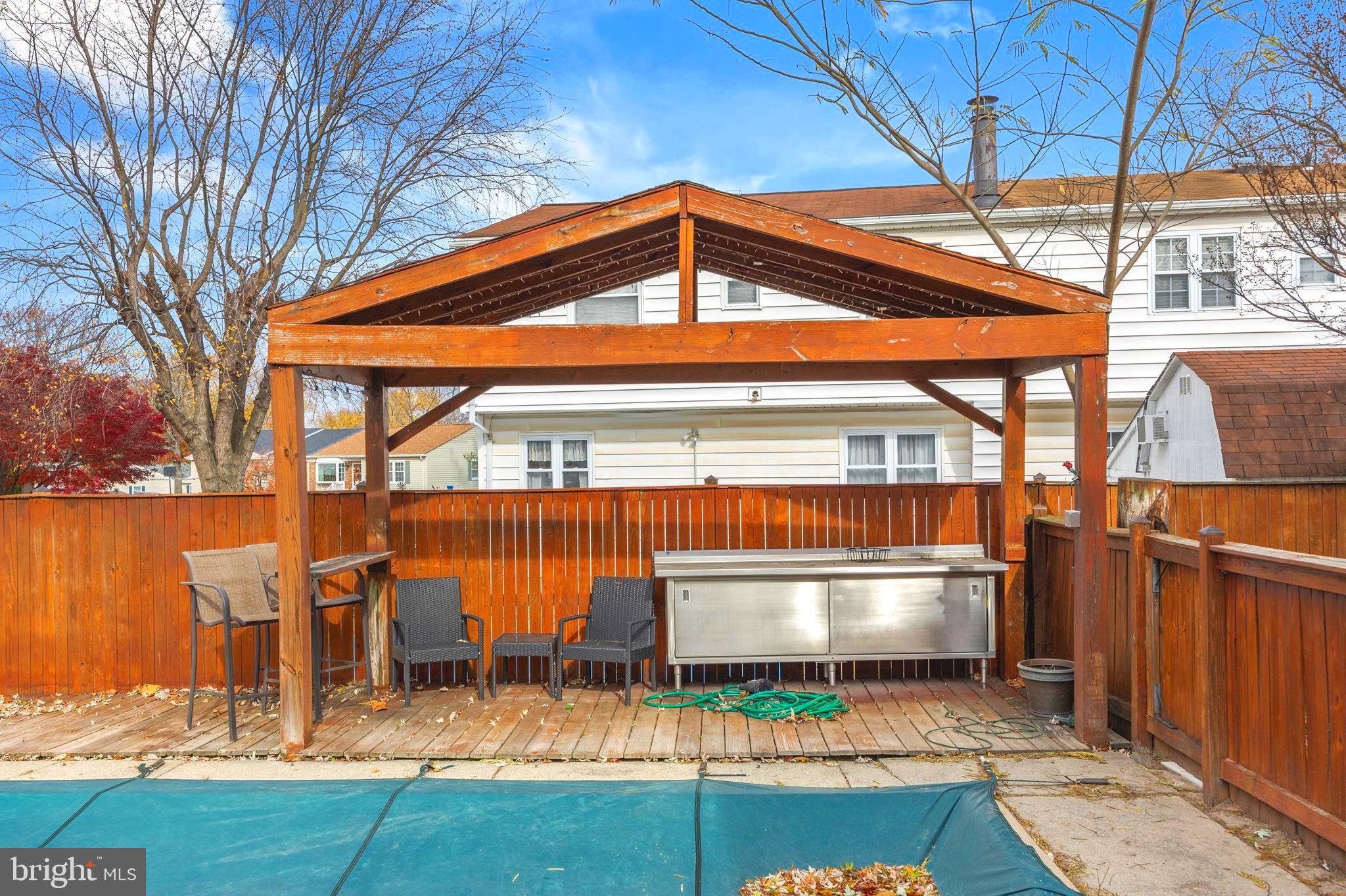 7740 Notley Road Pasadena, MD 21122 - Photo 31 of 46 a backyard of a house with yard and outdoor seating