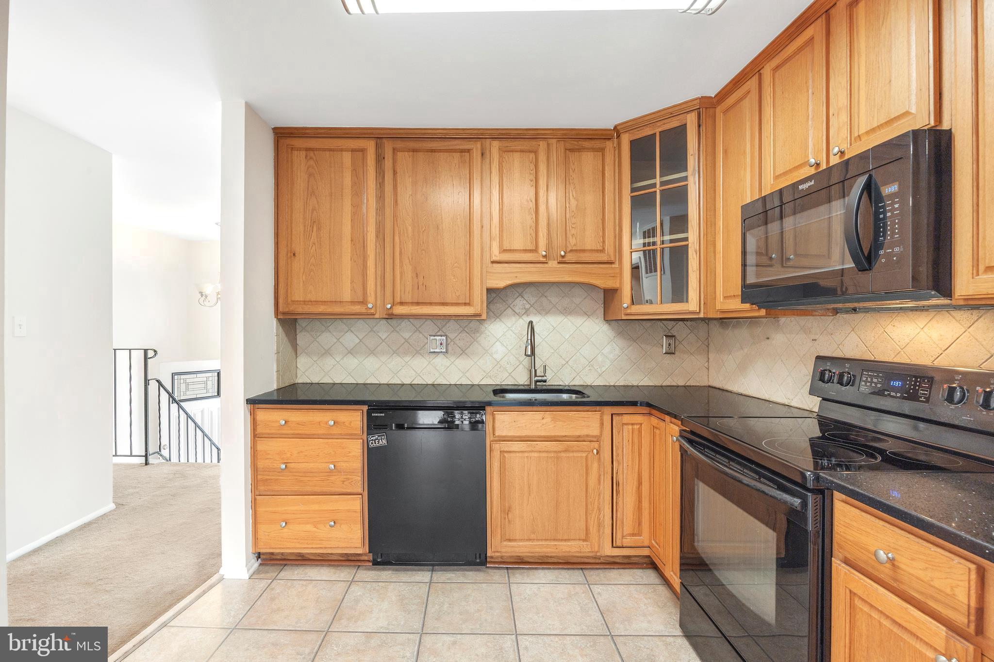 7740 Notley Road Pasadena, MD 21122 - Photo 4 of 46 a kitchen with stainless steel appliances granite countertop a stove a sink and a microwave