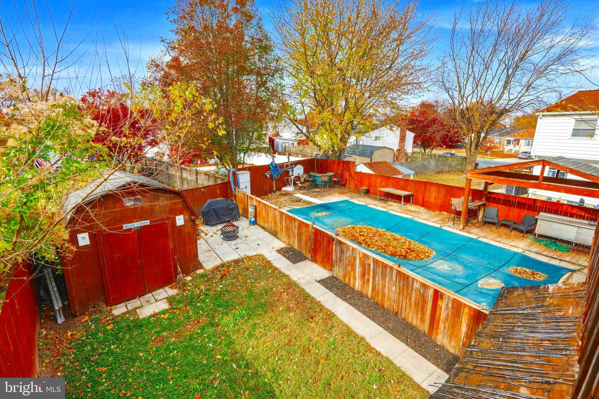 7740 Notley Road Pasadena, MD 21122 - Photo 6 of 46 a view of a swimming pool with a bench and trees around