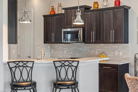 a kitchen with stainless steel appliances granite countertop a sink and cabinets