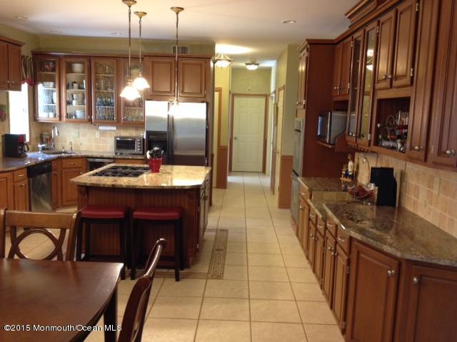 292 Nottingham Road Morganville, NJ 07751 - Photo 12 of 22 a kitchen with kitchen island granite countertop a sink appliances and cabinets