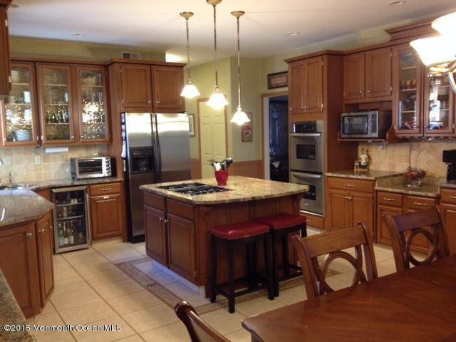 292 Nottingham Road Morganville, NJ 07751 - Photo 13 of 22 a kitchen with stainless steel appliances granite countertop a stove a sink and a refrigerator