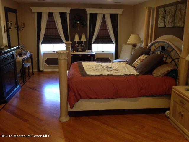 292 Nottingham Road Morganville, NJ 07751 - Photo 18 of 22 a bedroom with a bed next to a window