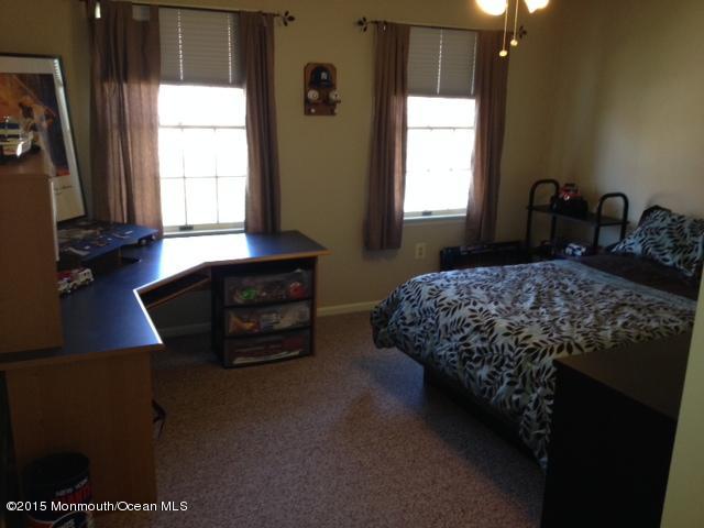 292 Nottingham Road Morganville, NJ 07751 - Photo 21 of 22 a bedroom with a bed and a window