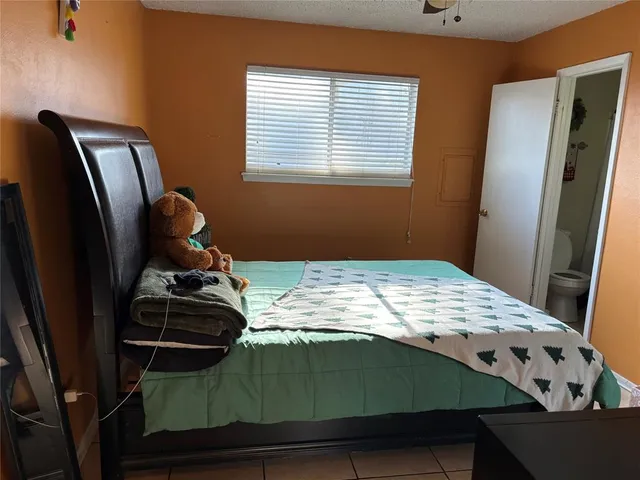 a bedroom with a bed and cabinets