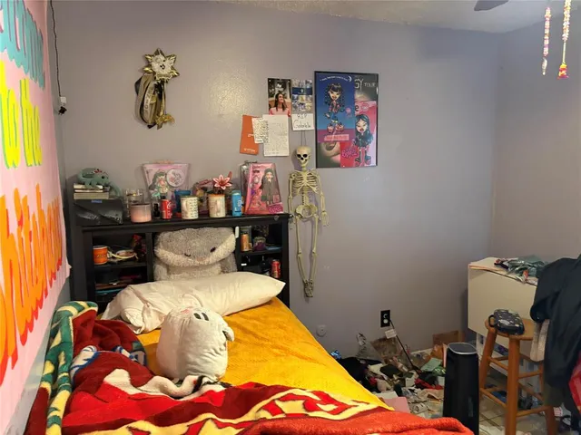 a bedroom with bed and a chandelier