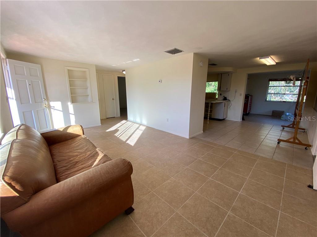 3612 Springfield Drive Holiday, FL 34691 - Photo 4 of 13 a living room with furniture and a flat screen tv