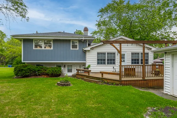 a view of a house with a yard and sitting area