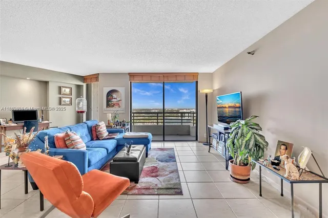a living room with furniture a rug and a flat screen tv