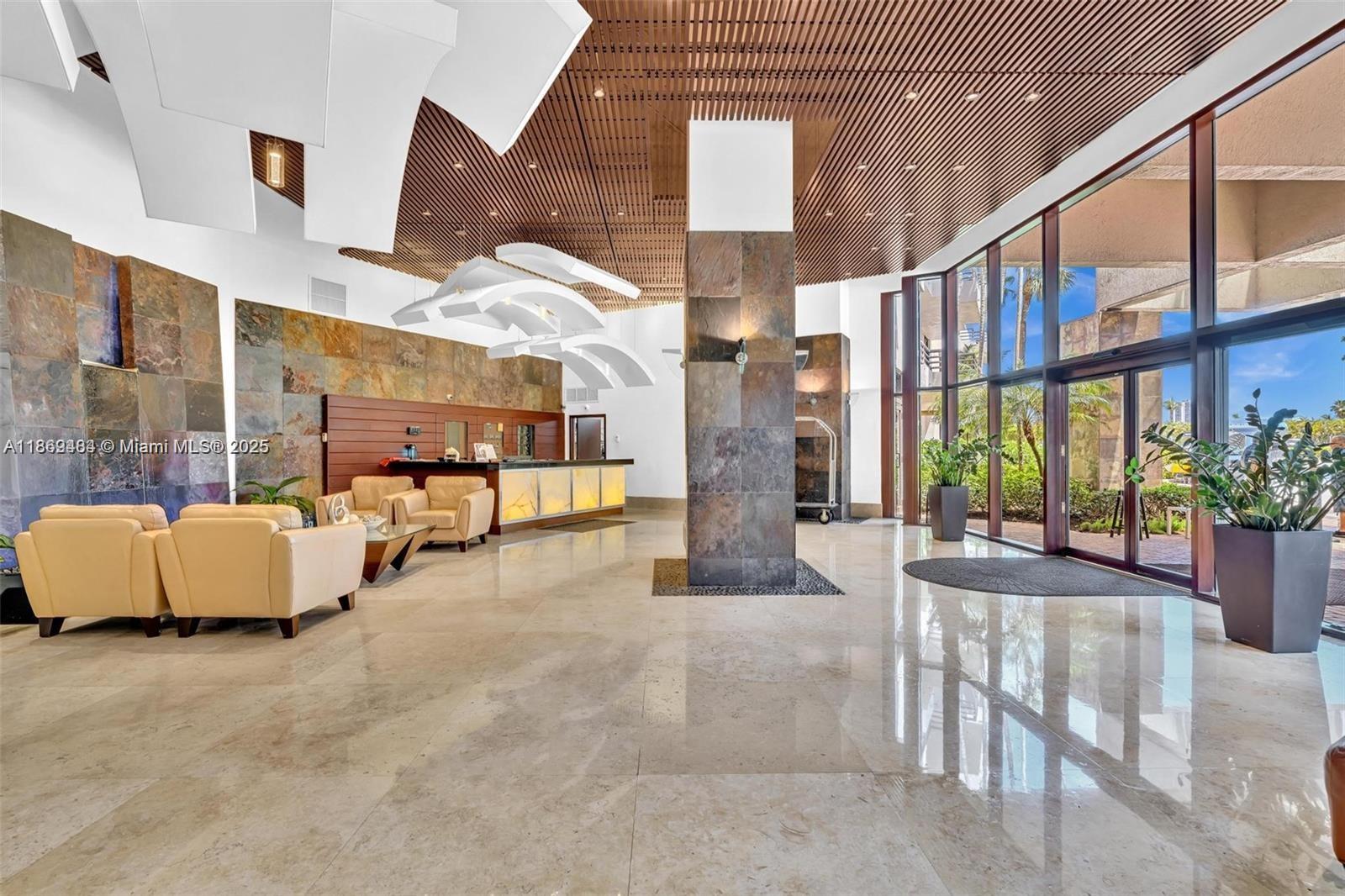 3300 Northeast 191st Street, Unit LP04 Aventura, FL 33180 - Photo 14 of 16 a view of an entryway with floor to ceiling windows and entryway