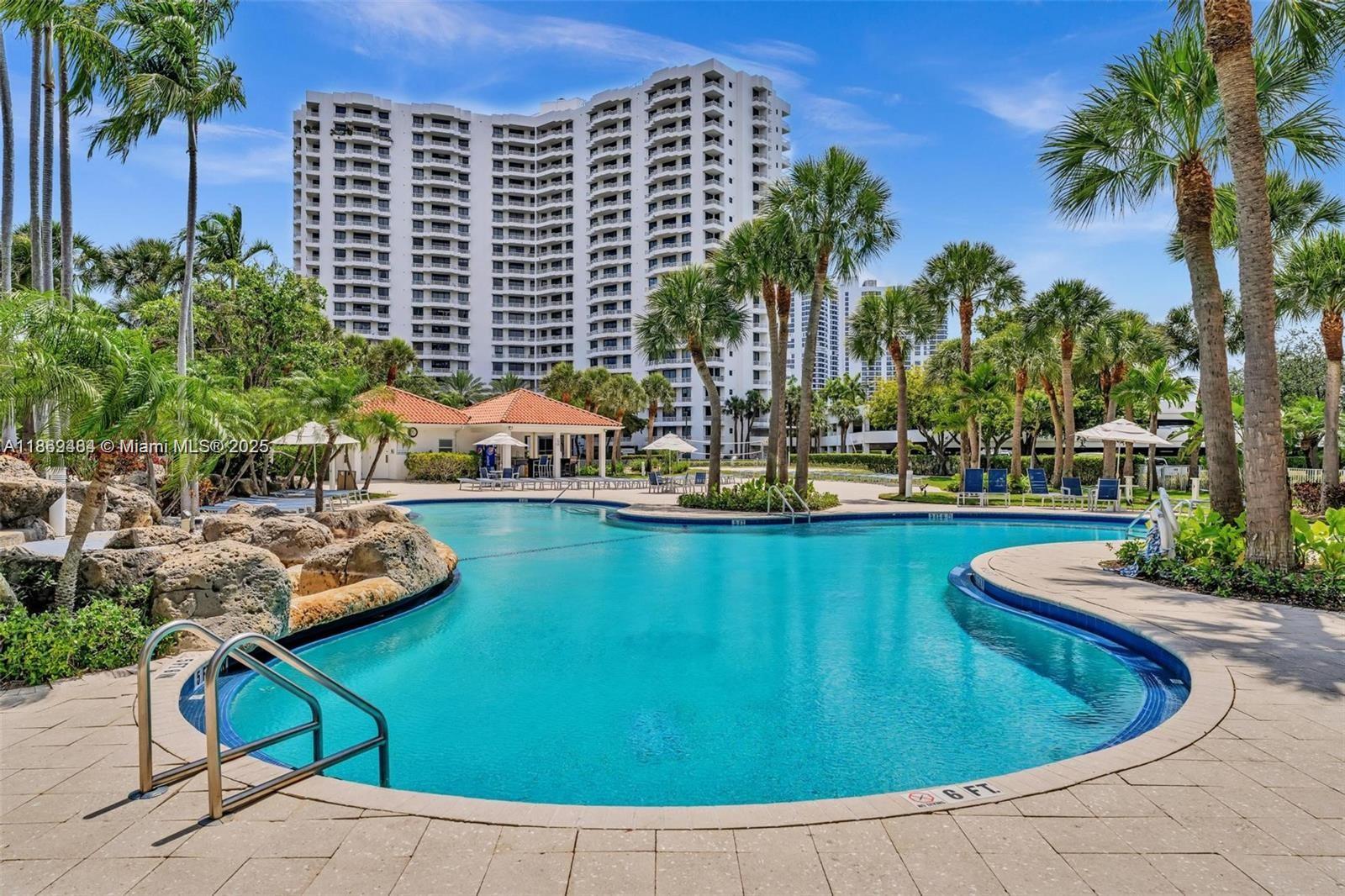 3300 Northeast 191st Street, Unit LP04 Aventura, FL 33180 - Photo 15 of 16 a view of a swimming pool with chairs