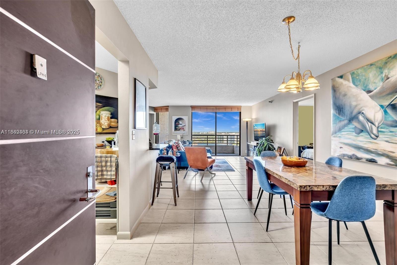 3300 Northeast 191st Street, Unit LP04 Aventura, FL 33180 - Photo 7 of 16 a outdoor space with lots of furniture and a chandelier