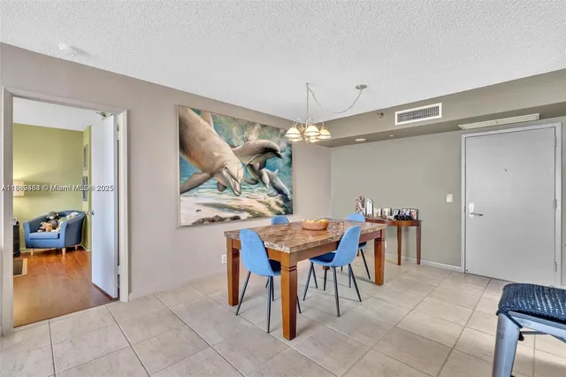 a dining room filled with furniture and a chandelier