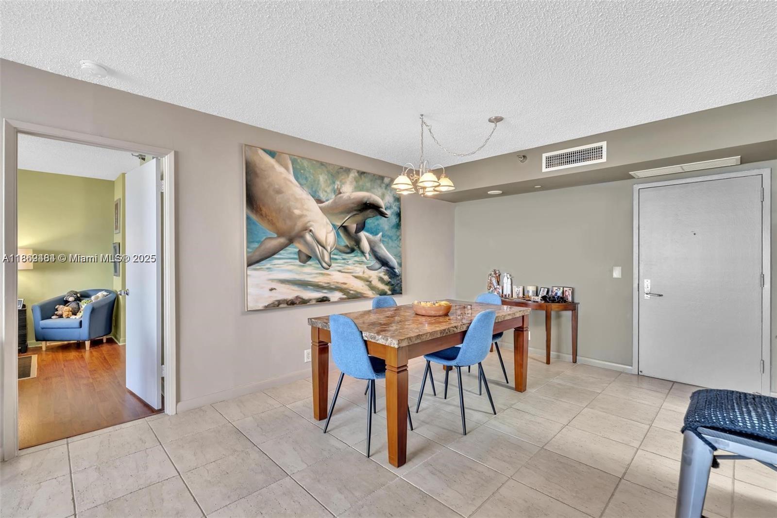 3300 Northeast 191st Street, Unit LP04 Aventura, FL 33180 - Photo 10 of 16 a dining room filled with furniture and a chandelier