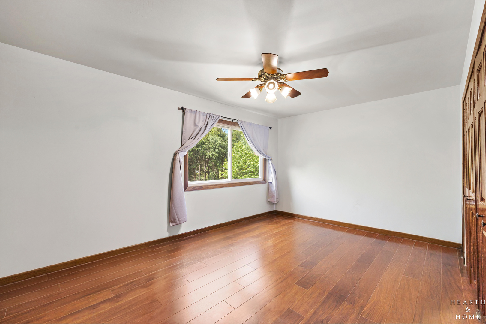 506 Old Hunt Road Fox River Grove, IL 60021 - Photo 19 of 44 an empty room with wooden floor fan and windows