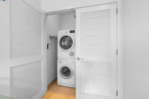 a view of a hallway with entryway and wooden floor