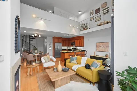 a living room with furniture a fireplace and a window