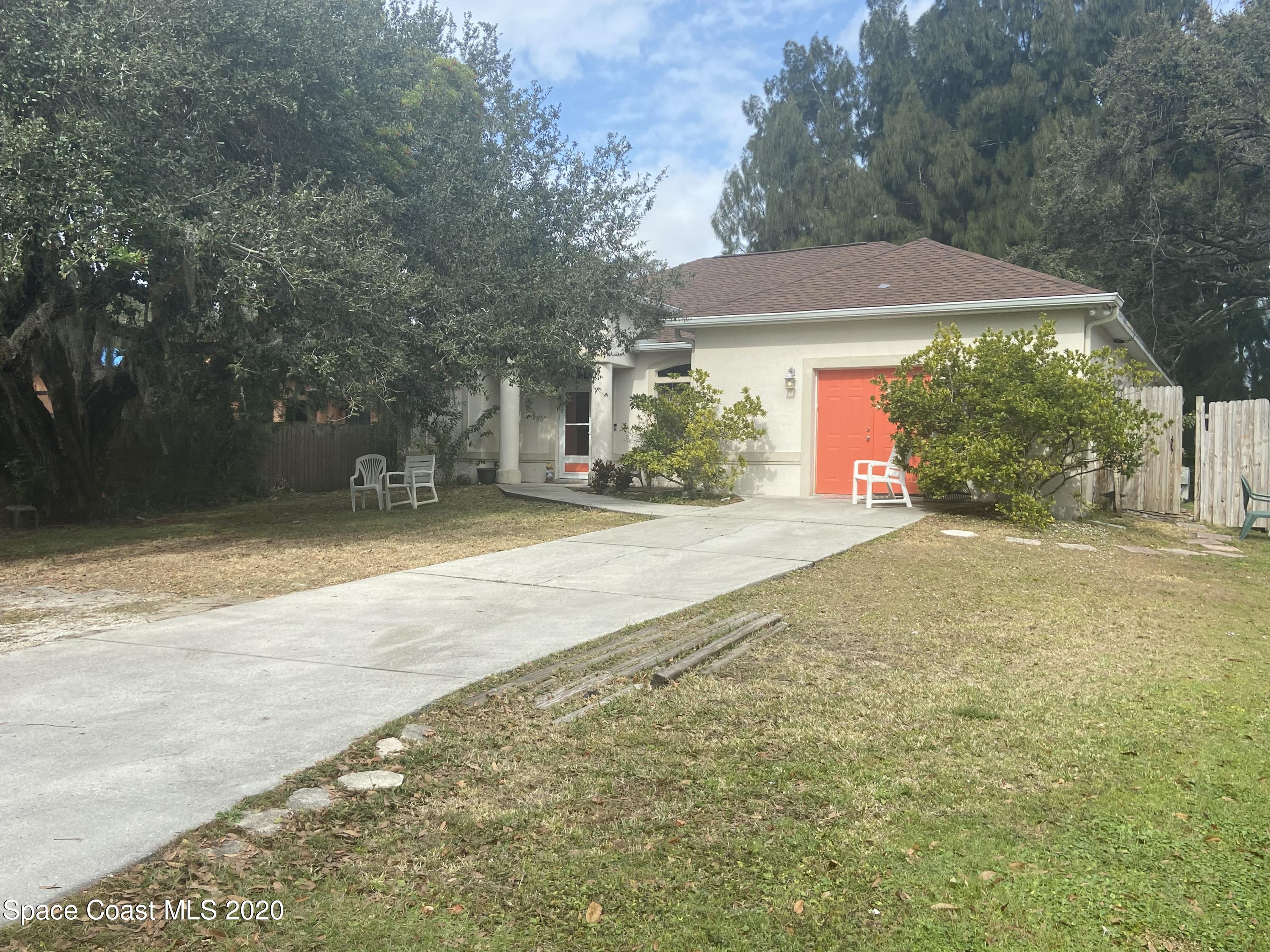 3150 Aurora Road Melbourne, FL 32934 - Photo 2 of 8 a view of a house with backyard and a tree