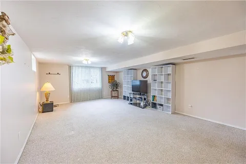 a view of a livingroom with furniture and a window