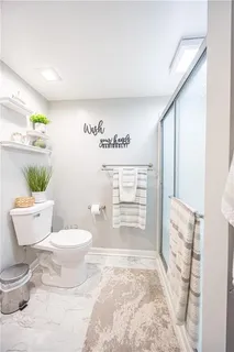 a bathroom with a sink toilet and shower