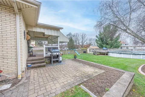 a chair and table sitting in backyard of the house