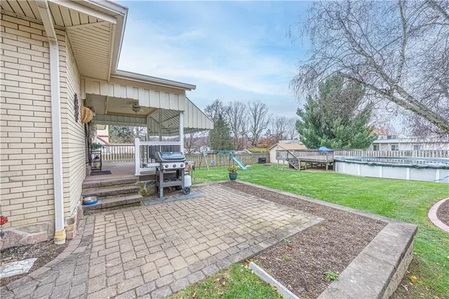 a chair and table sitting in backyard of the house