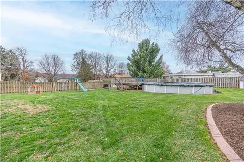 a view of a garden with a building in the background