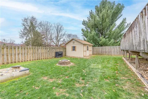 a view of a backyard with a garden and deck