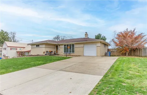 a aerial view of a house with a yard and garage