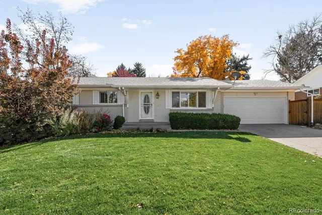 a view of a house with a patio and a yard