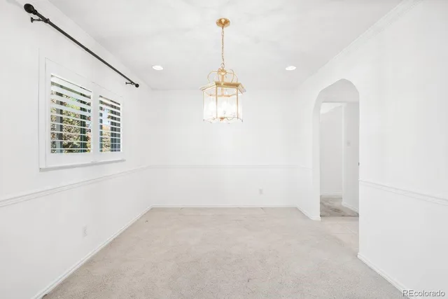 a view of a room with a window and chandelier