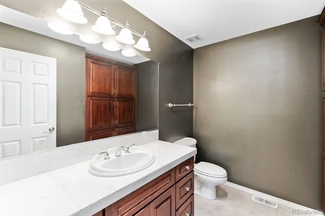 a bathroom with a sink a toilet and mirror