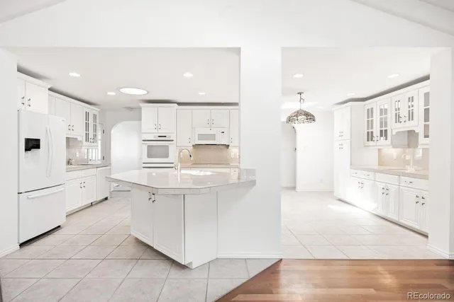a large kitchen with kitchen island a sink stainless steel appliances and cabinets
