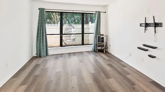 wooden floor in an empty room with a window