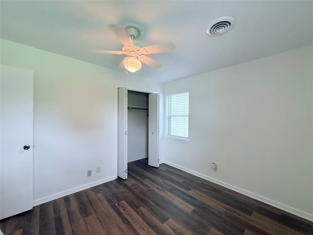 160 Bob White Road Denison, TX 75020 - Photo 24 of 29 Room featuring wood-finish flooring, white walls, and a ceiling fan with integrated lighting