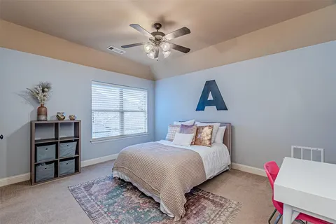 a bedroom with a bed and a large window