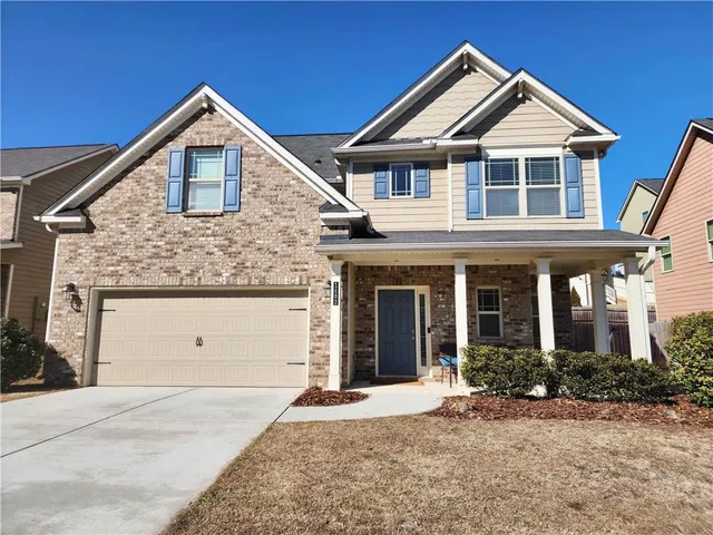 a front view of a house with a yard and garage