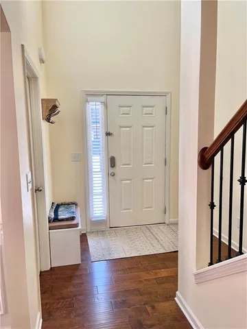 a kitchen with stainless steel appliances granite countertop a stove a sink dishwasher a microwave oven a stove with white cabinets and wooden floor