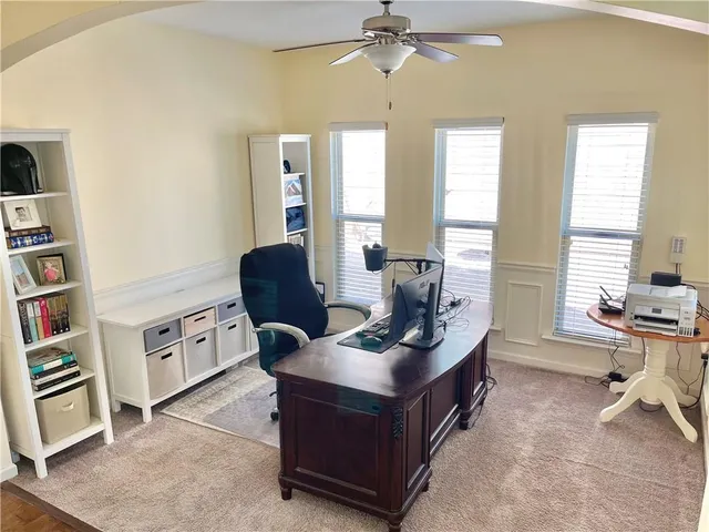 a kitchen with a refrigerator a stove a sink dishwasher a dining table and chairs with wooden floor