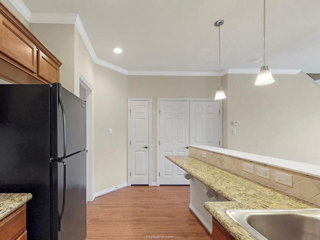 1198 Jones-Butler Road, Unit 2607 College Station, TX 77840 - Photo 4 of 26 a kitchen with stainless steel appliances granite countertop a refrigerator a sink and a stove